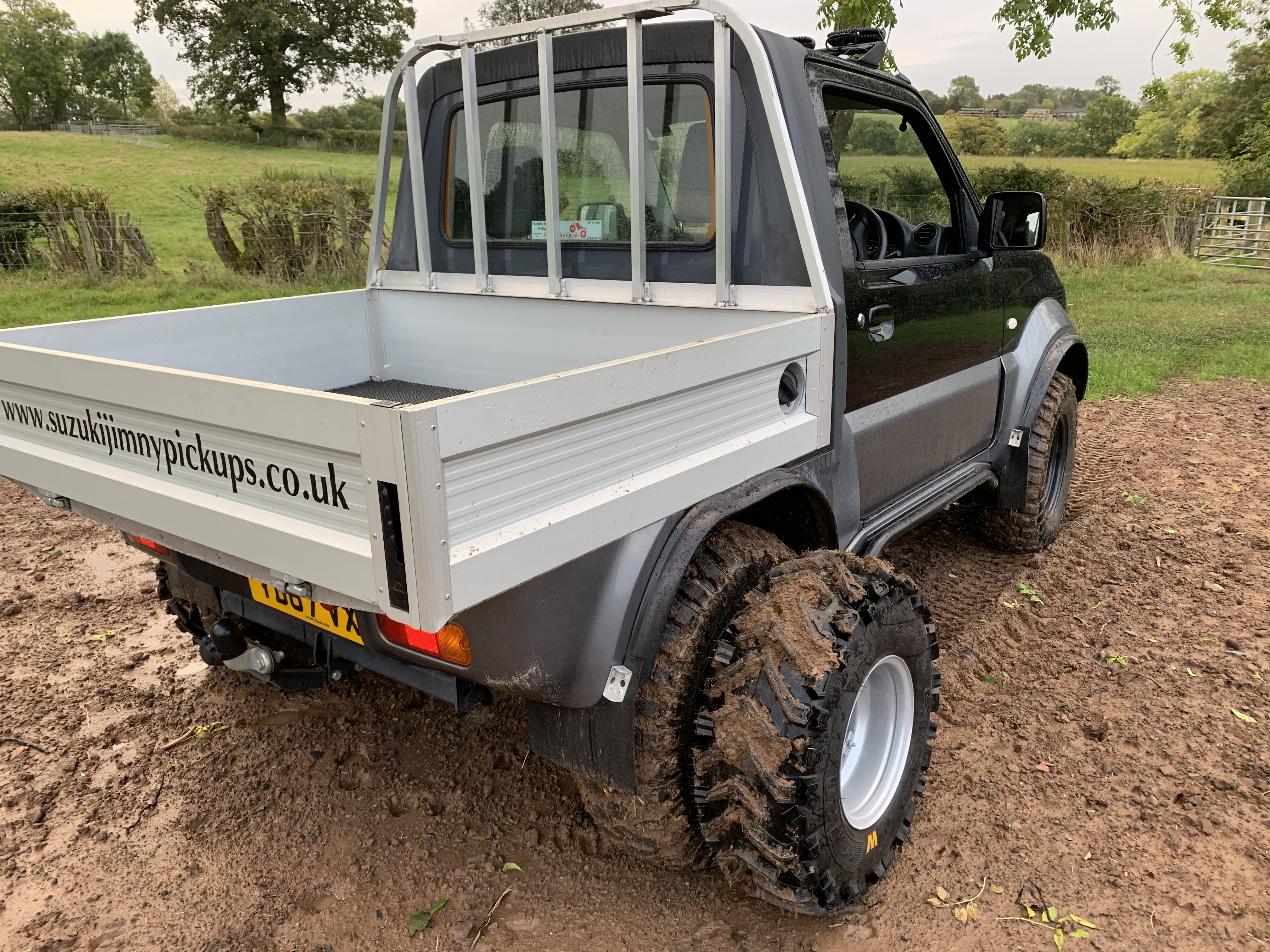 Suzuki Jimny pickup with dual wheel system fitted.